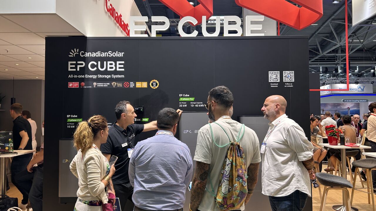 EP Cube representative explaining next-generation energy storage products on display wall to attendees at Intersolar Europe 2026 booth